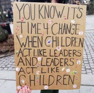 Sign about Greta and the children acting more like leaders than adults Climate change Global warming